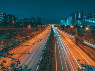 Light trails along a busy highway in perspective at night