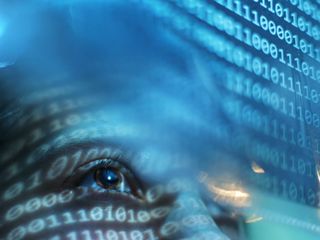 Person looking on blue screen lit with binary code