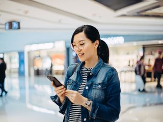 Woman using smartphone at the shopping mall