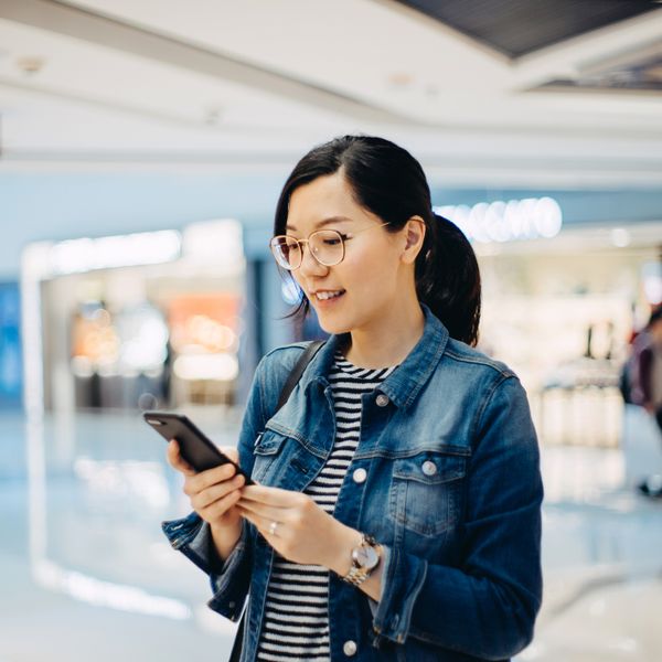 Woman using smartphone at the shopping mall