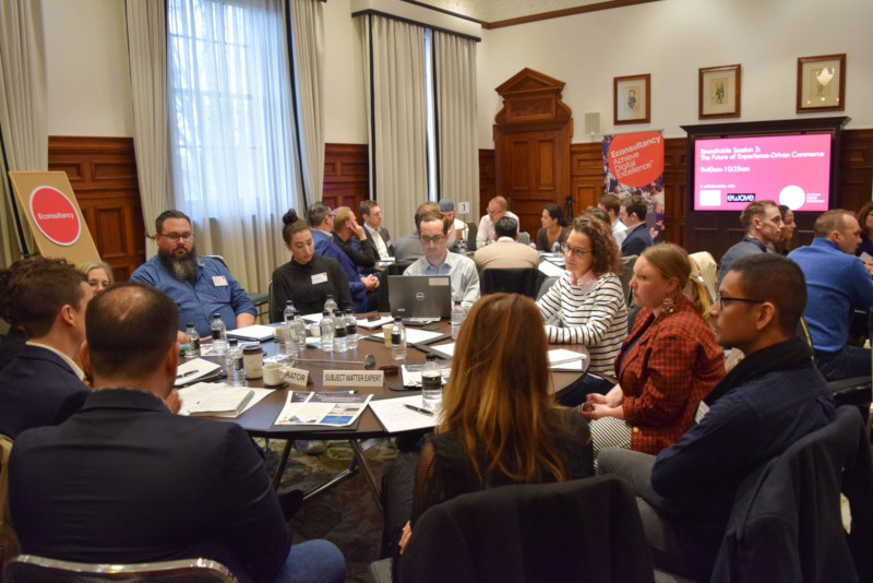 Group of people sitting around a table at Econsultancy meeting