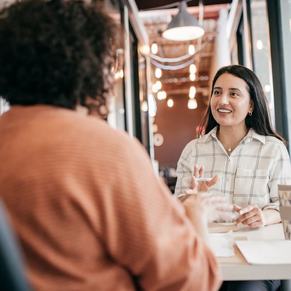 Two women looking at each other and talking