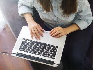 Woman working on laptop at home
