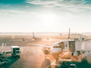 Airplanes in airport at sunrise