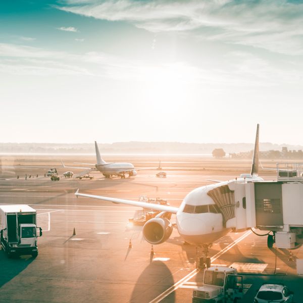 Airplanes in airport at sunrise