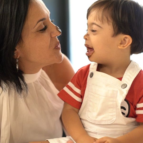 mom and child with down syndrome having fun while eating chocolate