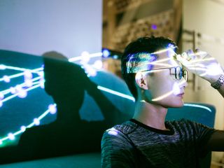 A person with a hand on the head and lights shining through