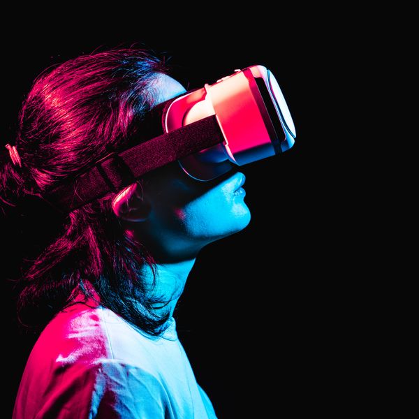A woman using virtual reality headset in a dark room