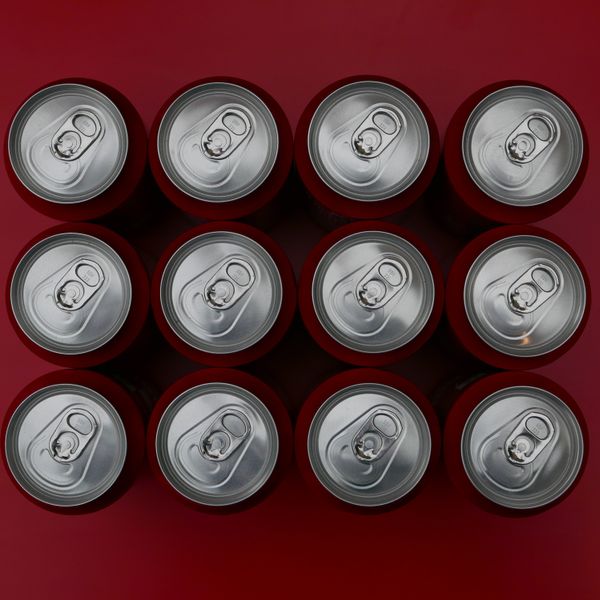 Drink cans on red background