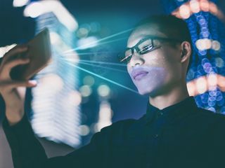 Man using facial recognition on a mobile phone