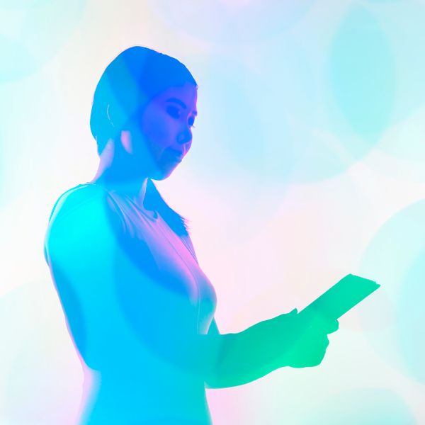 Woman holding a tablet with a blue filter